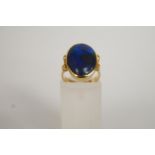 A black opal ring, set in yellow metal,