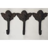 A cast iron coat hook modelled as cherub