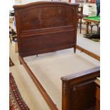 An early 20th century French walnut bed