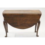 An early 19th century oak gate leg table