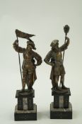 A pair of spelter figures each on a marb