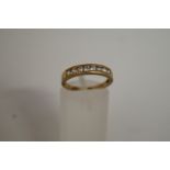 A 9ct gold cubic zirconia half hoop ring