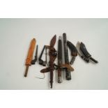 A collection of various knives, swords a