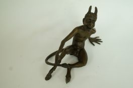 A bronze model of the devil
