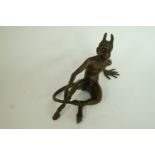 A bronze model of the devil