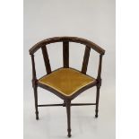 An Edwardian mahogany corner chair