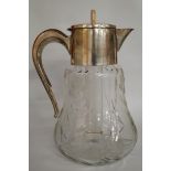 A glass lemonade jug with plated mounts,