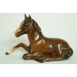 A Beswick brown foal, sitting