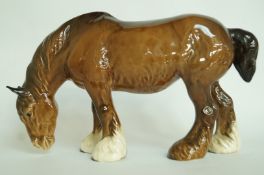 A Beswick grazing shire horse
