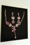 A necklace and earrings set, of purple p
