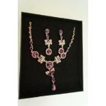 A necklace and earrings set, of purple p