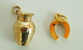 A jug charm, stamped '9ct'; and a small