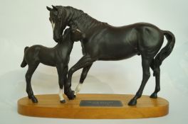 A Beswick Black Beauty and foal
