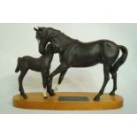 A Beswick Black Beauty and foal