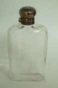 A large glass hip flask, with silver cap