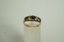 A sapphire and diamond ring, stamped '18