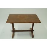 An oak Arts and Crafts table with a copp