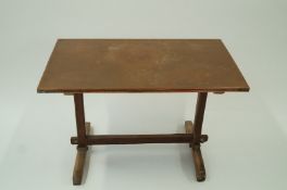 An oak Arts and Crafts table with a copp