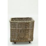 A wicker laundry basket, on wheels