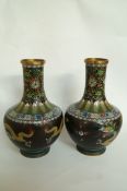 A pair of black ground cloisonné vases w