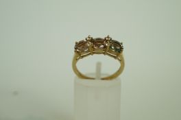 A three stone 9ct gold ring, set with ov