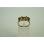 A three stone 9ct gold ring, set with ov