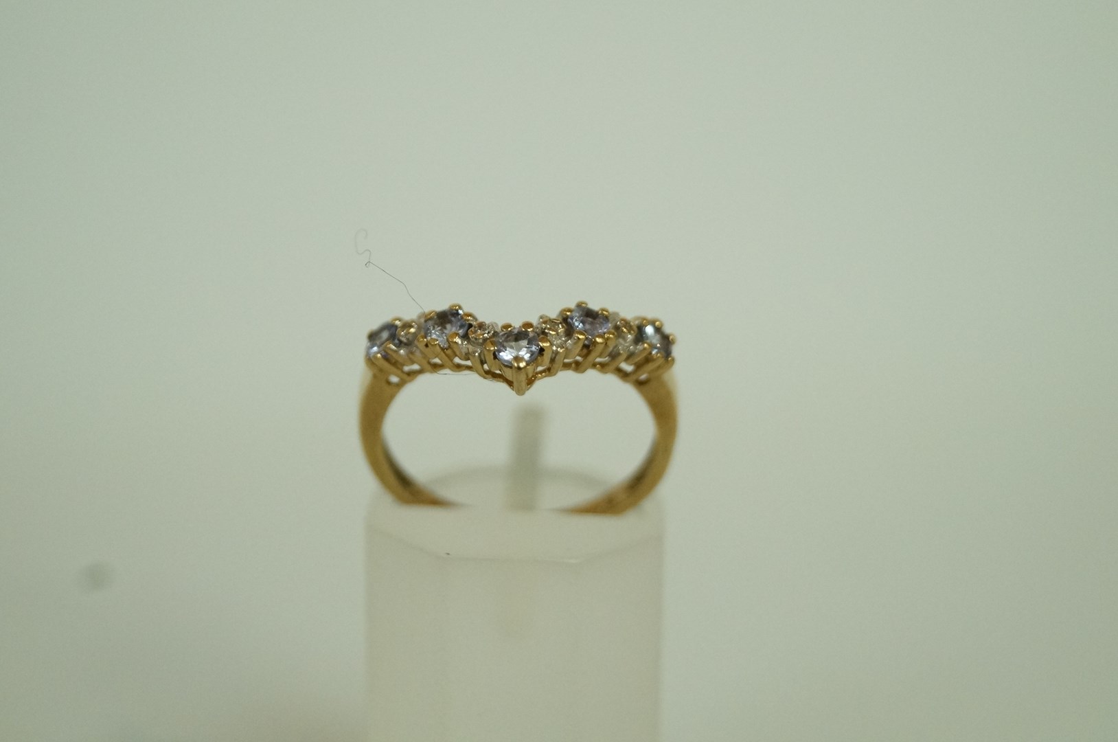 A tanzanite and diamond 9ct gold wishbon
