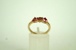 A three stone 9ct gold dress ring, set w