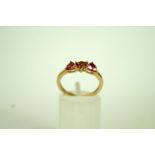 A three stone 9ct gold dress ring, set w