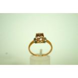 A 9ct gold dress ring set with a facette