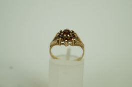 A 9ct gold garnet cluster ring, finger s