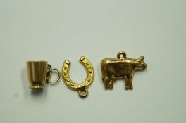 A 9 carat gold cow charm; with a 9 carat