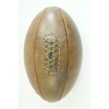 A leather rugby football, embossed "John