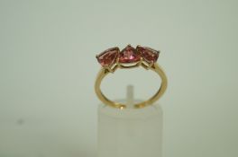 A 9ct gold three stone dress ring, finge