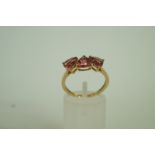 A 9ct gold three stone dress ring, finge