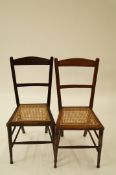 Two mahogany chairs each with a cane sea