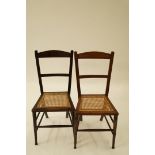 Two mahogany chairs each with a cane sea