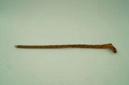 A walking stick carved with a foot and d