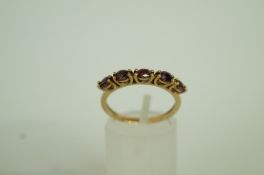 A five stone garnet 9ct gold ring, finge
