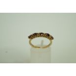 A five stone garnet 9ct gold ring, finge