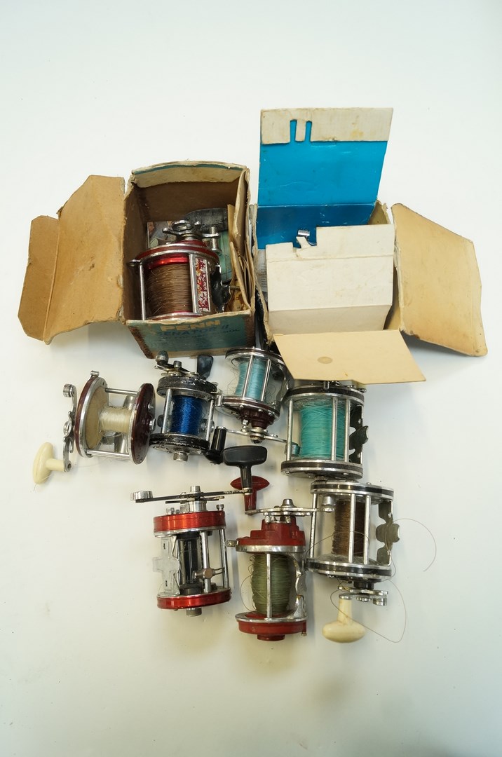 A collection of fishing reels, various m