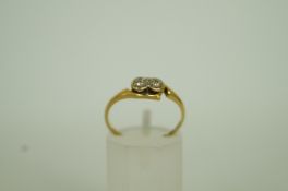 A two stone diamond cross over ring, sta
