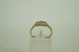 A three stone diamond ring, stamped '18c