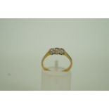 A three stone diamond ring, stamped '18c