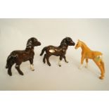 A Beswick figure of a palomino foal, printed marks in black H 9.5cm, two others of bay foals, one