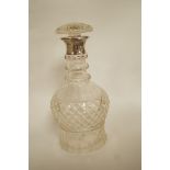 A glass decanter with a silver collar, Deakin & Deakin, Sheffield 1927, the body of inverted