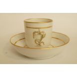 A Factory Z porcelain coffee cup and saucer, painted engrise with an urn within gilt line bands