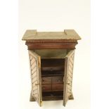 A stained pine smokers cabinet with two doors opening to reveal a drawer and cupboard door, H 49cm