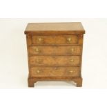 A 20th century walnut veneer chest of four drawers with fold over top, H 76.5cm W 68cm D 34cm