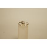 A diamond single stone ring, the brilliant cut of approximately 0.12 carats, high claw set to an